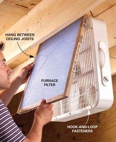 a man is fixing an air conditioner on the ceiling with instructions to fix it