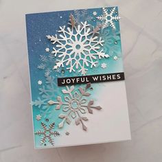 a card with snowflakes and joyful wishes written on it