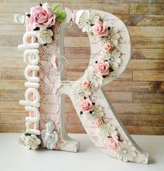 the letter k is decorated with pink flowers and white letters that spell it's birthday