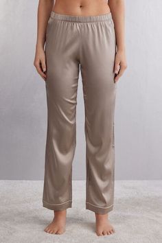 Full length pants in light stretch silk satin with contrast trim, available in different colors, at the hem. Elegant and comfortable, they are perfect for a nighttime outfit or refined loungewear. Elegant Satin Pants For Loungewear, Elegant Satin Long Pants Sleepwear, Elegant Satin Sleepwear With Long Pants, Satin Lounge Pants With Elastic Waistband, Satin Pants With Elastic Waistband For Loungewear, Comfortable Satin Lounge Pants, Elegant Wide Leg Bottoms For Pajama Party, Elegant Silk Bottoms For Loungewear, Elegant Ankle-length Loungewear Pants