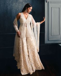 This sharara set features three-dimensional floral sequin, pearl and crystal embroidery. The outfit is paired with embellished v neck top and a four-sided embroidered net dupatta.From Seema Gujral’s Fiori collectionDELIVERY TIMEPlease allow 8-12 weeks for your outfit to arriveFABRIC DETAILSNetProfessional cleaning only Floral Sharara, Seema Gujral, Sharara Designs, Sangeet Outfit, Crystal Embroidery, Indo Western Dress, Indian Dresses Traditional, Designer Party Wear Dresses, Party Wear Indian Dresses