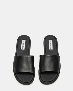 Classic Black Slides With Textured Footbed, Classic Slides With Leather Footbed, Classic Slides With Removable Insole, Classic Flat Slides With Removable Insole, Classic Slides With Rubber Sole, Classic Synthetic Slides, Classic Black Slip-on Slides, Classic Flat Slides For Spring, Classic Black Flat Slides