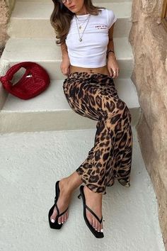 Made from a silky material that hugs you in all the right places, the Leopard Slim Fit Maxi Skirt is a mix of cute and sexy. Dress it up with a pair of kitten heels and a blazer, or dress it down with sneakers and your favorite tee! 95% satin, 5% spandex Slim Fit Low Rise Side Zipper Size Guide in Images!