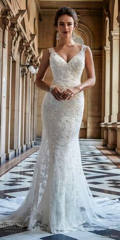 a woman in a wedding dress standing on a tiled floor with an ornate archway behind her