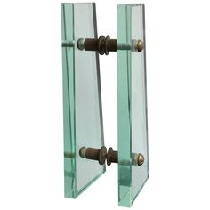 a pair of glass door handles on a white background