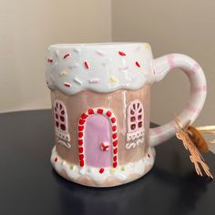 a ceramic mug with a house on it