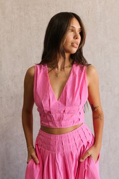 Front view of female model wearing the Valery Pink Cropped Tank which features Pink Cotton Fabric, Cropped Waist, Upper Pleated Details, V-Neckline, Sleeveless and Back Tie Closure with Light Wood Beads Jumpsuit Shorts Rompers, Vacation Dresses, Hair Fragrance, Maxi Dresses Casual, Dress Jewelry, Romper Pants, Pink Cotton, Crop Tank, Spring Dresses