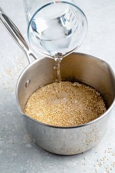 a silver pot filled with sand and water