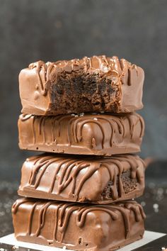 three pieces of chocolate cake stacked on top of each other