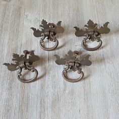 four antique door handles with leaves on them