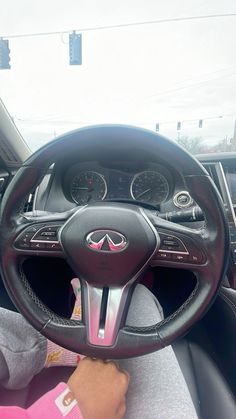 the interior of a car with steering wheel and dashboard