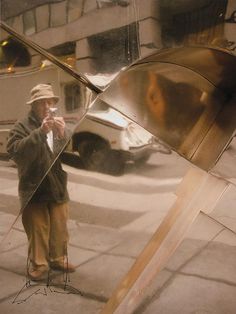 a man standing next to a large metal object