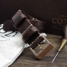 "At Cozy Handmade, we pride ourselves on using the highest quality materials for our products. This NAT2 watch strap is made of premium full grain Italian veg tanned leather from one of the best tanneries in Italy. The leather features gorgeous texture and natural characteristics which will give your watch an instant rugged and vintage stylish look. Its appearance will get even better with time as it acquires patina, wrinkles and marks. The color of Military 103 is a combination of different sha Rugged Leather Watch Bands For Everyday Use, Vintage Leather Watch Accessories For Everyday Use, Leather Watch Accessories With Adjustable Strap For Everyday Use, Rugged Brown Leather Watches, Everyday Vintage Brown Leather Watch Band, Vintage Brown Leather Watch Bands For Everyday Use, Leather Watch Bands With Waxed Finish, Brown Leather Watch Band With Adjustable Strap, Brown Leather Strap Watch Accessories For Everyday