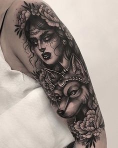 a woman with a wolf tattoo on her arm