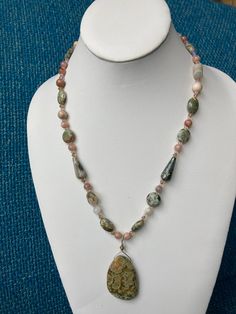 Jasper pendant and Ocean Jasper necklace with Sunstone, Rhyolite finished in Swarovski Crystals with a sterling clasp Necklace is 20 1/2 inches in length All my necklaces are different and would be considered one of a kind. View my collection of Kingman Arizona Turquoise here: https://www.etsy.com/shop/MoonwaterJewelryShop?section_id=28192591  I've been selling on eBay since 2003 Came to Etsy to sell jewelry. Returns and exchange details ► RETURNS / EXCHANGES All items are handcrafted and custom pieces therefore we don't usually accept returns or exchanges on jewelry unless the fault was ours. Screens do not always reflect the same colors as well as seeing them in person. However, I understand that these pieces are very sentimental and important, so If you do have an issue with your produc Silver Necklaces With Ocean Jasper Natural Stones, Silver Necklaces With Natural Ocean Jasper Stones, Ocean Jasper Gemstone Pendant Necklace, Ocean Jasper Necklace, Arizona Turquoise, Jasper Necklace, Jasper Pendant, Ocean Jasper, Themed Jewelry