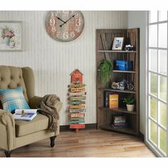 a living room filled with furniture and a large clock on the wall above it's bookshelf