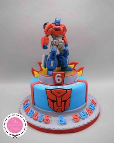 a birthday cake with a transformer figure on top