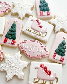 decorated cookies are arranged on a white surface