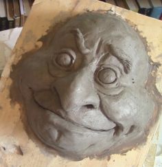 a clay face sitting on top of a table