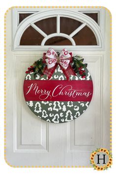 a christmas door hanger with two bows on it