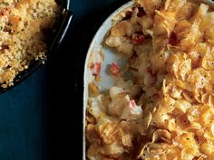 a casserole dish filled with macaroni and cheese next to a skillet