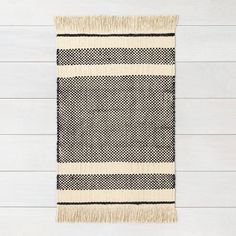 a black and white rug hanging on a wall