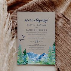 a wedding card with the words we're cloping on it and mountains in the background