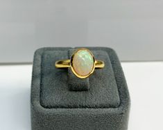 Certificated Natural Opal Dainty Cabachon Ring * 14K Solid Gold & Genuine Opal Stone * Best Gift for her * Handmade Ring ◎ Details ◎ ○ Gemstone Details .Natural OPAL Oval Cut 10.16X8.09 mm approx. 1.53 ct ○ Gold Details 14K Solid Gold Width of Band : 3.00 mm Weight of Ring : approx 4.60 gr Made to Order HANDMADE ITEM ○ Upgrade to Solid 18K Gold, please click the link below: https://www.etsy.com/listing/962826004 ◎ For more CABACHON BEZEL rings : http://etsy.me/37fvI60 All of our jewelleries Dainty Band, Topaz Color, Bezel Ring, Best Gifts For Her, Unisex Ring, Opal Stone, Dainty Ring, Natural Opal, Gold Details