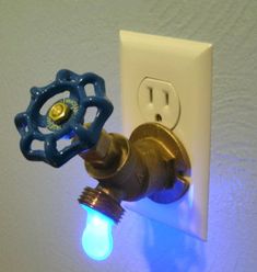 a light switch with a blue and yellow light on it's side next to a white wall