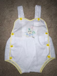 In GVC. Tiny stain pictured. No other visible stains/tears. No size tag, refer to photos for measurements. Sleeveless Cotton Onesie For The Beach, Sleeveless Cotton Onesie For Beach, Cotton Sleeveless Beach Onesie, Sleeveless Yellow Cotton Bubble Romper, Yellow Cotton Bodysuit For Summer, Summer Vacation Cotton Onesie, White Summer Cotton Bodysuit, White Cotton Summer Bodysuit, Yellow Cotton Bubble Romper For Summer