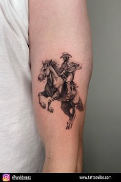 a man's arm with a tattoo of two cowboys riding horses on the back of his horse