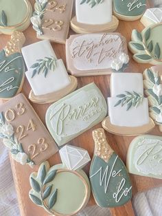 many decorated cookies on a wooden table