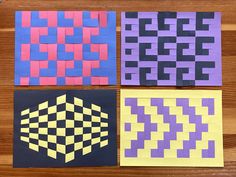 four pieces of paper with different patterns on them sitting on top of a wooden table