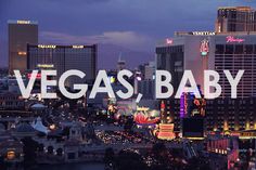 the las vegas baby sign is in front of some tall buildings and neon lights at night