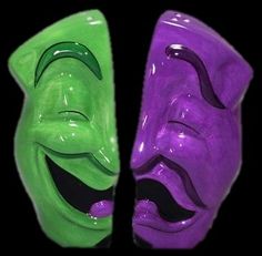 two green and purple masks with faces painted on them