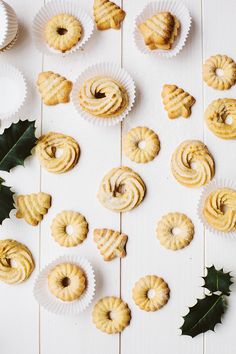 christmas pastries and holly leaves on a white table