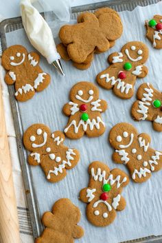 ginger cookies decorated with icing on a baking sheet