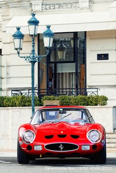 a red sports car is parked on the street