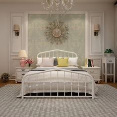 a white bed sitting in a bedroom next to a chandelier