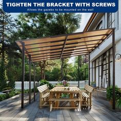 a wooden table and chairs under a pergolated roof on a deck with trees in the background