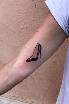 a woman's arm with a shoe tattoo on the left side of her arm