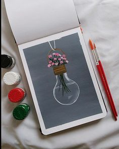 a card with flowers in a vase and watercolor paints