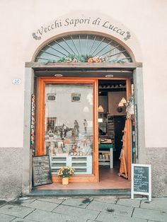 the front entrance to a store with an open door