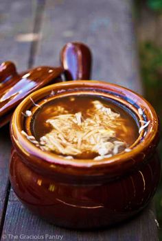 a wooden bowl filled with food on top of a table