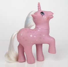 a pink toy pony with white hair and stars on its tail