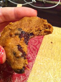 a half eaten cookie sitting on top of a red and yellow plate with a bite taken out of it