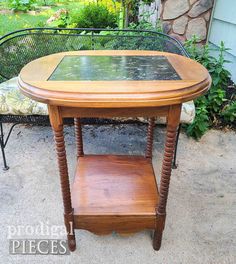 an old table has been turned into a side table with glass top and wooden legs