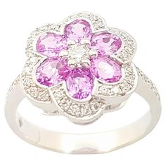 Pink Sapphire 1.25 carats with Diamond 0.26 carats Ring set in 18K White Gold Settings Width: 1.3 cm Length: 1.3 cm Ring Size: 52 Total Weight: 4.44 grams "We first opened doors in 1980 when it was then situated in the vicinity of the Victory Monument; a small and modest storefront with a couple of counters. From its humble beginnings to where it stands today, our company has proven its abilities as a jeweler. Since the beginning, we have been supplying fine quality pieces to dealers, wholesalers and customers worldwide. From then till now, our business still interrelates its name with quality products and excellent service, where commitment and sincerity toward customers will always be its motto." Diamond Flower Ring, Diamond Flower, Flower Ring, Sapphire Diamond, Cluster Ring, Pink Sapphire, Ring Set, Ring Sets, Jewelry Rings