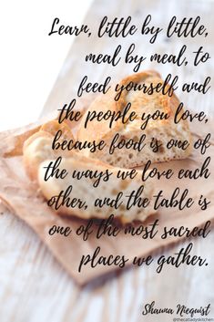 a piece of bread sitting on top of a wooden table next to a quote about eating