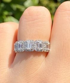 a woman's hand with a diamond ring on it